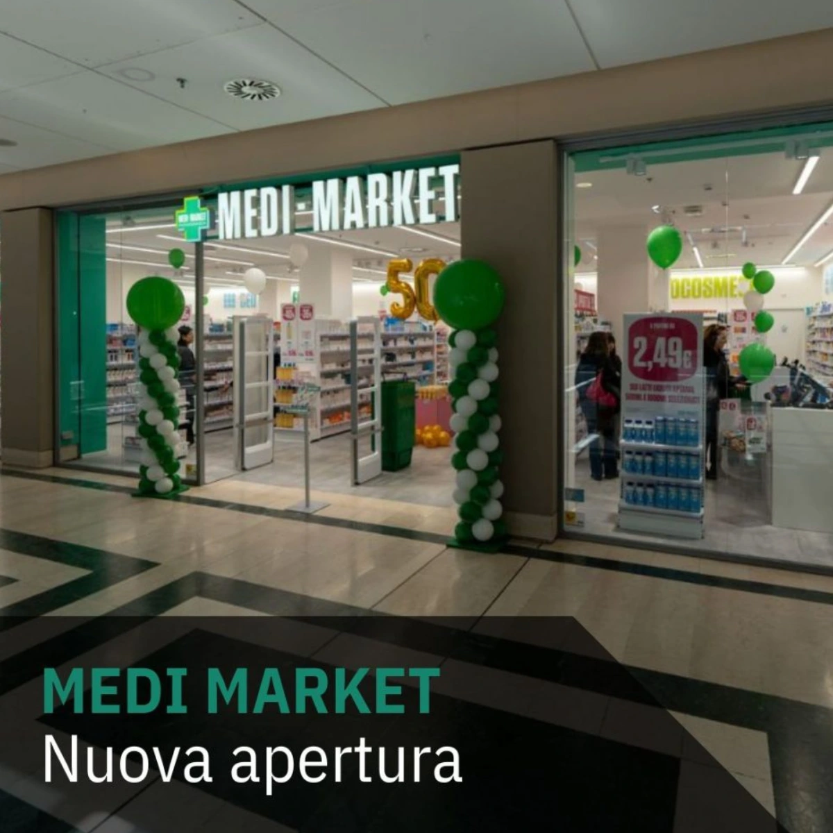 Ingresso del negozio Medi Market al Lingotto Torino con decorazioni verdi e bianche per la nuova apertura.